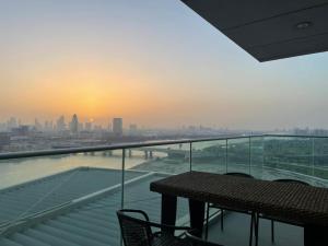 a balcony with a table and a view of the city at Luxurious Penthouses in Dubai