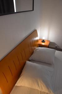 two beds in a room with a headboard and a table at Le Zen appartement balnéo Grenoble in Grenoble