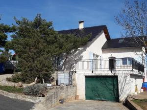 a white house with a green garage at VIDAL BERNARD in Saint-André-de-Vézines