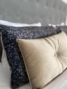 a pillow on a bed with a blue and white patterned pillow at Björkuddens Hotell & Restaurang in Sandöverken