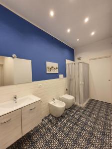 a bathroom with a toilet and a sink and a shower at Airport Home TUREI & BRINGO Car Rental in Cinisi