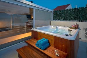 a jacuzzi tub in the middle of a house at SEAFRONT NORTH HOUSE SUTIVAN - new luxury three-bedroom villa - unforgettable panoramic views of the sea - roof terrace with jacuzzi - first row next to the beach and right next to all facilities - secured parking in Sutivan +39 photos