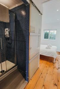 a bathroom with a shower and a glass door at The Bolthole in Kingsbridge