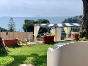 a white chair in a yard with a gazebo at Acquamarina in Gaeta