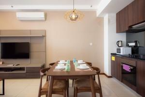 a kitchen and dining room with a table and chairs at The Landmark Penang in Tanjong Tokong