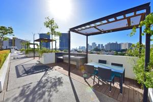 a rooftop patio with a blue table and chairs at The Landmark Penang in Tanjong Tokong