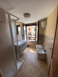 a bathroom with a tub and a toilet and a sink at La Torre della Piramide in Pitigliano +29 photos