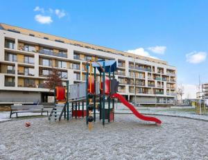 a playground in front of a apartment building at Sunflower - Modern large charming apartment with balcony in Bratislava