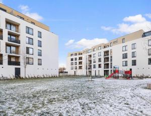 an empty playground in front of two buildings at Sunflower - Modern large charming apartment with balcony in Bratislava