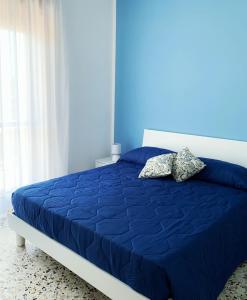 Un pat sau paturi într-o cameră la Villa Ginevra