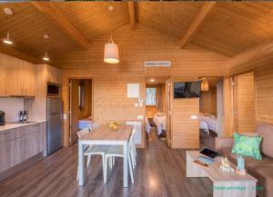 a kitchen and living room with a table in a room at Camping Cala Llevado in Tossa de Mar