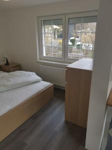 ein Schlafzimmer mit einem Bett und einem großen Fenster in der Unterkunft Ferienhaus KaTi Whg1 in Knüllwald