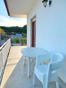 a white table and chairs on a balcony at Villa Ginevra in Paestum