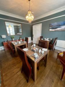 a dining room with a table and chairs at Crown House in Inverness