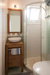 a bathroom with a sink and a shower and a toilet at L'Aigrette - Front de mer-Accès direct plage in Leucate