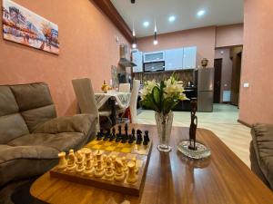 a living room with a chessboard on a table at Metta Tbilisi Apartment in Tbilisi City