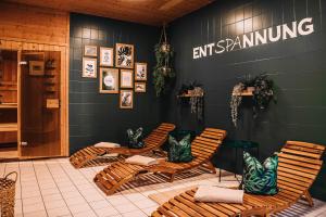 a store with rocking chairs and an exit numbing sign on the wall at XXL Ferienhaus Goldberger See - Sauna - 16 Personen in Goldberg