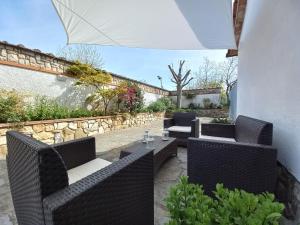 a patio with two wicker chairs and a table at Tuscany To Love - Holiday Home - Casa Vacanze in Pieve a Nievole +51 photos