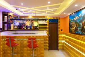 a bar with red stools in a restaurant at Grand Yak Boutique Hotel in Kathmandu +31 photos