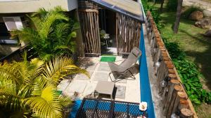 an overhead view of a patio with a chair and a pool at sweet island studio ocean in Rivière Noire