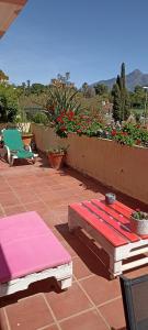 a patio with a table and chairs and flowers at Cozy Room with sunny terrace in Marbella