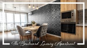 a kitchen and dining room with a table and chairs at The Boulevard Luxury Apartment in Sofia