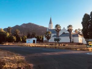 a church with a steeple on the side of a road at 31 on Kloof in Aurora