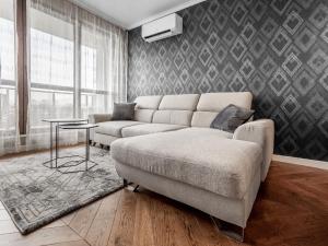 a living room with a couch and a table at The Boulevard Luxury Apartment in Sofia