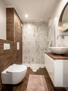 a bathroom with a white toilet and a sink at The Boulevard Luxury Apartment in Sofia