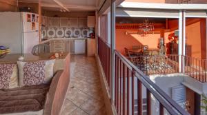 a balcony with a couch and a dining room and kitchen at Riad Palmi magnifique Riad centre ville - 6px in Agadir