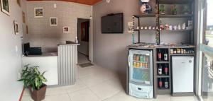 a room with a refrigerator in a room at Pousada Angela in Urubici