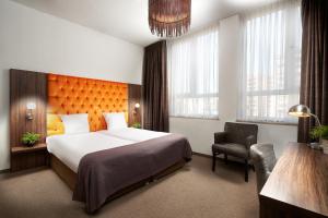 מיטה או מיטות בחדר ב-Hotel La Reine