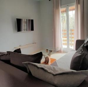 a person sitting on a couch in a living room at GioDa Studios in Perama