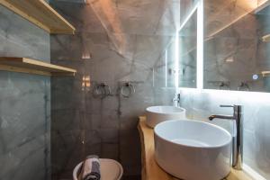 a bathroom with two sinks and a mirror at Xigia Escape villas in Khartáta