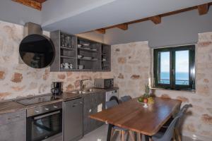 a kitchen with a wooden table and a wooden dining table at Xigia Escape villas in Khartáta