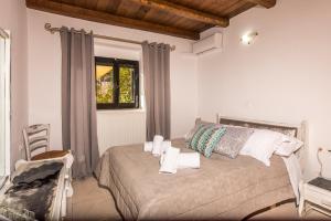 a bedroom with a bed with towels on it at Xigia Escape villas in Khartáta +37 photos
