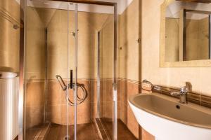 a bathroom with a shower and a tub and a sink at Xigia Escape villas in Khartáta