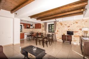 a kitchen and living room with a table and chairs at Xigia Escape villas in Khartáta