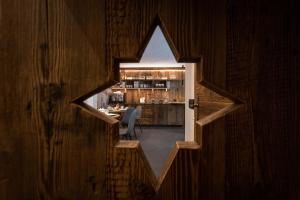 a view of a room with a bar through a window at B&B Al Mulin in Padola