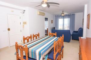a bedroom with a bed and a blue couch at Miramar - Goya in Carboneras