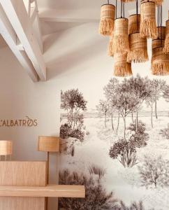 a mural of trees on a wall in a room at Hôtel L'Albatros in Saint-Trojan-les-Bains