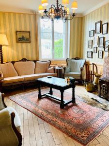 a living room with a couch and a coffee table at Les 3 Gamins in Boussac