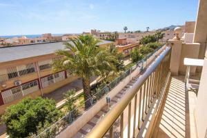 a balcony with palm trees and a building at Miramar - Goya in Carboneras