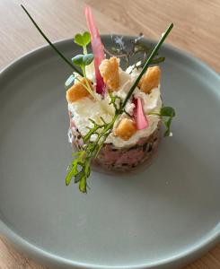 a dessert on a plate on a table at Hôtel L'Albatros in Saint-Trojan-les-Bains