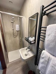 a bathroom with a shower and a sink and a shower at Crown House in Inverness