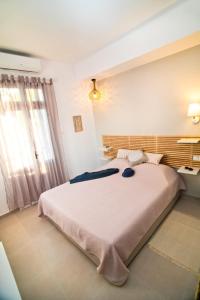 a bedroom with a large bed in a room at Sunshine Apartment in Kalymnos