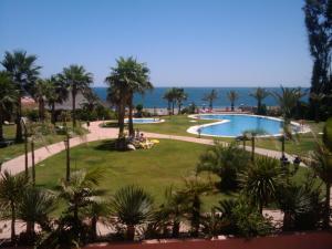 a view from the balcony of a resort with a swimming pool at Don Juan Beach Resort in Estepona
