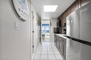 a kitchen with a large clock on the wall at 11-th Floor OcenView w Balcony cozy condo at Boardwalk Resort in Myrtle Beach