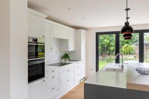 a white kitchen with white cabinets and a sink at Beautiful countryside home, 10min drive to Bath in Limpley Stoke