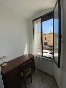a room with a desk and a window with a view at La Torre della Piramide in Pitigliano